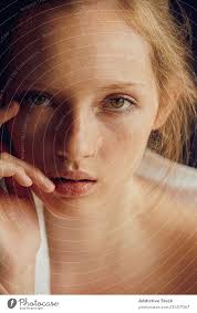 Smiling young woman touching virtual screen over white background. Sensual Young Woman Touching Lips And Face A Royalty Free Stock Photo From Photocase