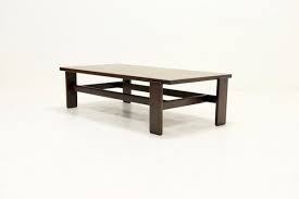 The thick solid top of the table is held up by metal accents that are perfectly balanced in harmony with the table. Asymmetrical Solid Wenge Wood Coffee Table 1960s For Sale At Pamono