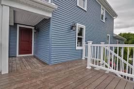 The deck should be below the door threshold to keep water out of the house. Blue Exterior Behr Marquee Paint Red Door Farm House Composite Decking Farm House Design Blue House Blue Exterior