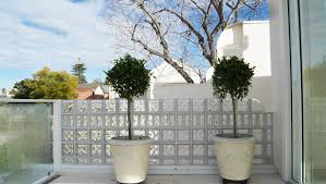 Lovely Sunlit Upstairs Patio With Glass Block Wall For Added Style And Privacy Glass Blocks Wall Glass Blocks Glass Brick