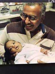 Gary holds a little Indian baby in his arms....