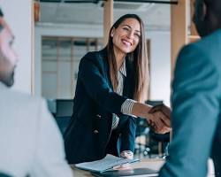 Image of Business owner shaking hands with insurance agent