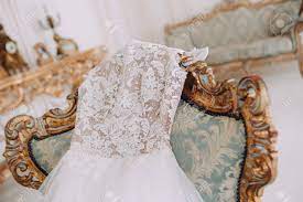 Lace curtains vintage lace floral lace paisley victorian french chic wedding dresses shopping. Wedding Dress Of The Bride Lies On A Chair In A Room With A Baroque Stock Photo Picture And Royalty Free Image Image 118657962