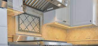 Now with the energy efficient led alternative, a 12v low voltage system allows homeowners to maximize the amount of fixtures on each run, and the installation requires less precautions than the 120v option, making led well light ideal for residential use. How To Choose The Best Under Cabinet Lighting Luxury Home Remodeling Sebring Design Build