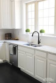 White kitchens with black cabinets on the island boast the room with a marble countertop. An Easy Kitchen Update That Makes A Huge Difference Making Lemonade
