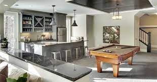Furnished Walkout Basement Design Gallery Interiors Exteriors Full Home Living Opening up the staircase into the basement allows it to have an inviting feel as you enter the room.