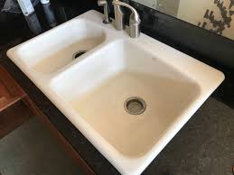 cast iron sink with a stainless sink