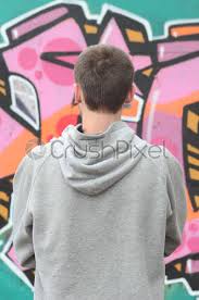 A Young Graffiti Artist In A Gray Hoodie Looks At Stock Photo Crushpixel