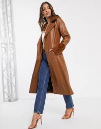 Take that morning chill off with a cosy puffer jacket, stride into work in a trendy trench coat or blazer, then rock a quilted leather biker jacket over the weekend. River Island Faux Leather Longline Trench Coat With Faux Fur Collar And Cuffs In Tan Asos