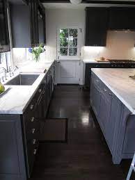 This cook space, for instance, combines farmhouse elements like the sink and the subway tile with dark slate floors. Dark Hardwood Floors And Grey Walls Shaped Kitchen Kitchen Island Hardwood Floors Dark Har Painted Kitchen Cabinets Colors Dark Grey Kitchen Grey Kitchens
