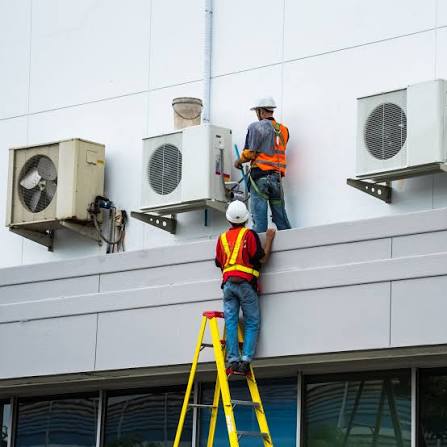 HVAC technician repairing an air conditioning unit