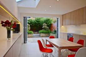 Bifold doors offer a transition rom the indoor wooden floorboards to the alternative wooden patio. Chiswick Contemporary Kitchen London By Really Nice Gardens Houzz