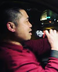 Mr. Chen, a Karaoke Taxi driver, singing during his dinner break, passing  by the Taipei nights. Shot while