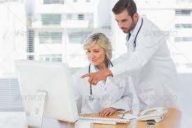 Two Concentrated Doctors Using Computer At Medical Office By Wavebreakmedia Two Concentrated Doctors Using Computer At M Medical Office Used Computers Medical