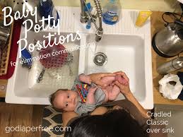 to hold a newborn baby over the potty
