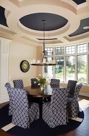 There's a fireplace and a couple of chairs. Modern Dining Area Ceiling Design