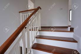 Whether grand and sweeping, rendered in wood, or a minimalist arrangment of metal and glass, the modern staircase is an example of literally elevated design. Brown Wooden Stair With White Steel Balustrade And Hardwood Handrail Stock Photo Picture And Royalty Free Image Image 142478392