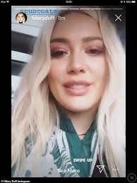 Hilary Duff glams it up in black leather leggings and a turquoise blouse  for holiday charity event