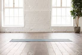Yoga Mat On Natural Wooden Floor In Empty Room In Fitness Center Comfortable Space For Doing Sport Ex White Brick Walls Infographic Social Media Graphics Yoga