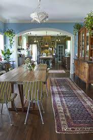 Rustic dining room interior with terracoota floor, brick vaults and fireplace, in teh foregroudn on the right the island kitchen. Rustic Dining Room Photos Design Ideas Remodel And Decor Lonny