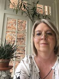 Who can repair a sentimental hat by undoing the stitching, putting in a new  strap, and stitching it back into place in Delaware, OH?