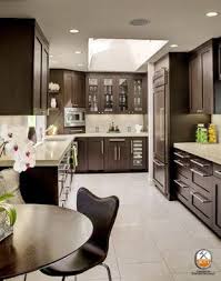Kitchen room with hardwood floor, brown cabinets with granite tops and tile back splash trim. Brown Kitchen Cabinets With Grey Floors Anipinan Kitchen