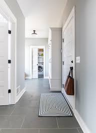 Clean kitchen design with white shaker cabinets paired with polished black granite countertops and white subway tile backsplash. Grey And Blue Mudroom The Lilypad Cottage