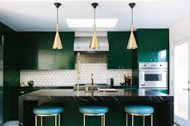 The ceiling features heavy, exposed wooden beams in a dark wood finish and a hanging wrought iron decorative candelabra. Green Kitchens Ideas For A Lively Space