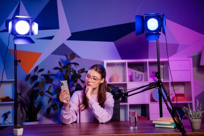 Female Content Creator in a Vibrant Home Studio Setting Recording a Vlog or Podcast Using Professional Equipment and Stock Photo - Image of reporter, record: 398548796