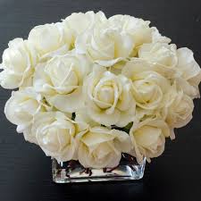 This artificial floral design consists of high quality silk white peonies. White Real Touch Rose Square Glass Arrangement Flovery