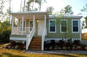 How Much Does A Tiny House Cost To Build A Prefab Home Wooden Stairs Wooden Siding Wall Mounted Lighting White Rail Small Modular Homes House Cost Prefab Homes