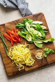Top View Of Bok Choy Red Bell Peppers Egg Noodles And Other Ingredients Needed For Making Chicken Ch Chicken Chow Mein Chow Mein Recipe Easy Chinese Recipes