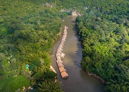 River definition, a natural stream of water of fairly large size flowing in a definite course or channel or series of diverging and converging channels. Awarded Kanchanaburi Floating Hotel Thailand River Kwai Jungle Rafts