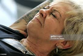 Shirley "Miss Dixie" Hammond grimaces while she gets a new tattoo at...  News Photo