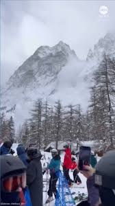 Avalanche coats skiers waiting in line for chair lift