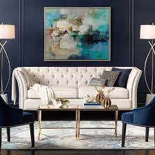 Angled Arms And Back Lend Graceful Elegance To The Charming Diamond Tufting And Nailhead Trim Feature Gold Living Room Living Room Decor Blue Living Room Decor