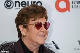Elton John, 75, dons a bejewelled suit and quirky glasses with David  Funrish, 60, at Oscars bash