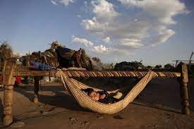 Qudsia Sadiq 5 Months Old Lay In A Hammock Attached To A Bed Outside Her Family S Makeshift Home While Her Mother Not Pictured Wa Photo Tranquillity Slums