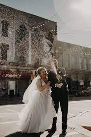 Bride And Groom Popping Champagne In The Street At Jake S Bar In Bay City Michigan Michigan Wedding Venues Michigan Wedding Photographer Michigan Wedding