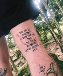 In the colored part of this tattoo design, calvin and hobbs are shown resting against a leafy tree, and the quote is inked above them in black. Quote Tattoo On The Thigh Tattoogrid Net