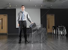 Isolated on a white background. Man Standing Next To A Pile Of Chairs Photo Image Picture Free Download 501509023 Lovepik Com