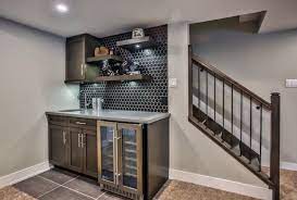 A basement wet bar within a game room is a typical choice in many homes. Smart Basement Bar Ideas Making Your Cellar Pub Sparkle Homes Tre Small Basement Remodel Basement Bar Basement Bar Designs