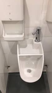 sink that drains into the urinal below