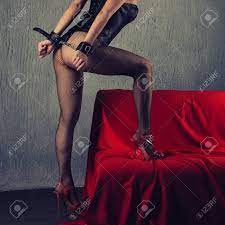 Beautiful Sexy Lady In Bdsm Outfit. Close Up Of Model With Hand In Bondage  Near Red Sofa - Toned Image Stock Photo, Picture And Royalty Free Image.  Image 137551953.