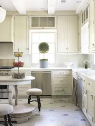 White cabinetry is a classic choice for a kitchen. Cream Kitchen Cabinets Cottage Kitchen Emily Followill Photography
