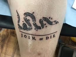 Placing the 'join, or die' tattoo on the chest is appropriate given the symbols origin representing bravery and patriotism. Join Or Die By Big Dave At Oxford Tattoo In Oxford Uk Tattoos Join Or Die Tattoo Back Tattoos For Guys Tattoos For Guys