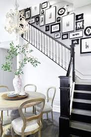 Black And White Gallery Wall Stairs Foyer Opens To Black And White Staircase Accented With Black And White Photo Wall Alongside An Eat In Kit Painted Staircases Townhouse Interior White Staircase