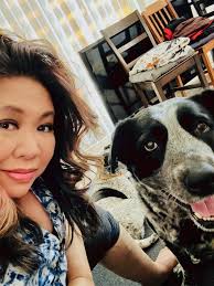 Violet the gargoyle sploots at the park