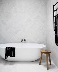 A frameless glass shower is fitted in a corner and accented with white subway surround tiles and honed marble mini herringbone floor tiles. The Tile Laying Patterns You Need To Know Zephyr Stone