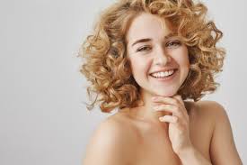Smiling girl with healthy wavy long blonde hair. Free Photo Beauty And Fashion Concept Carefree Beautiful Girl With Curly Hair And Naked Shoulders Smiling